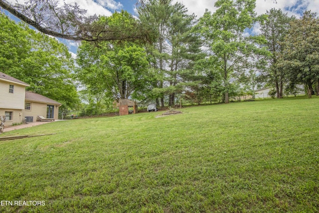view of grassy yard with central AC unit