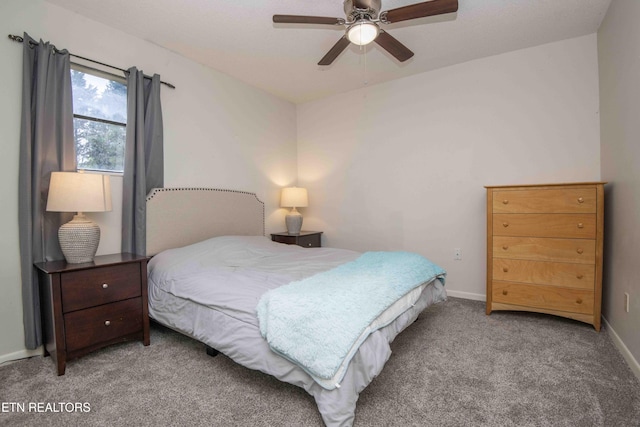 bedroom featuring carpet, baseboards, and a ceiling fan