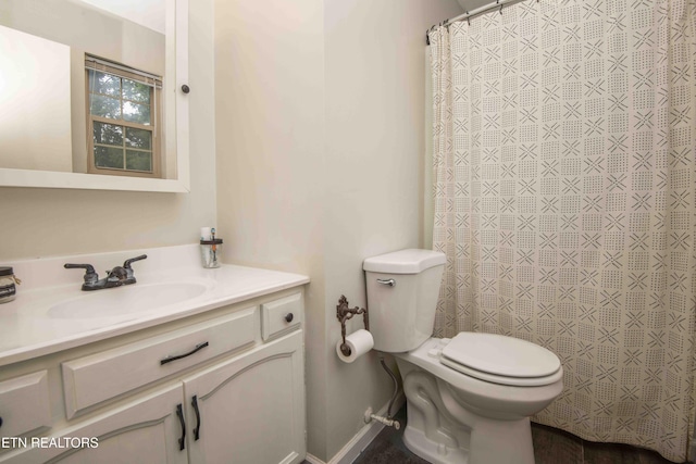 full bath featuring toilet, vanity, and curtained shower