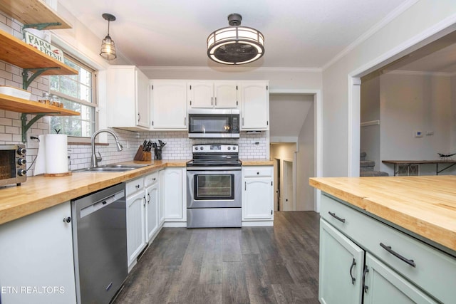 kitchen with stainless steel appliances, wood counters, a sink, open shelves, and crown molding