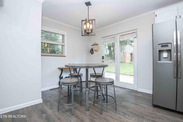 dining room with ornamental molding, baseboards, dark wood-type flooring, a chandelier, and healthy amount of natural light