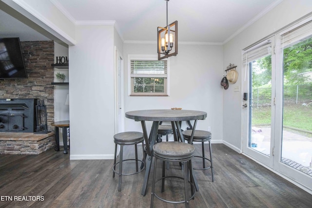 dining space with dark wood-style floors, baseboards, ornamental molding, and a chandelier