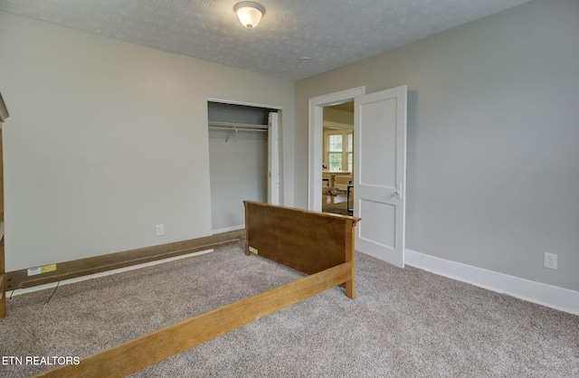 129 S Elmwood St, Knoxville, TN 37914 - unfurnished bedroom with carpet floors, a closet, a textured ceiling, and baseboards