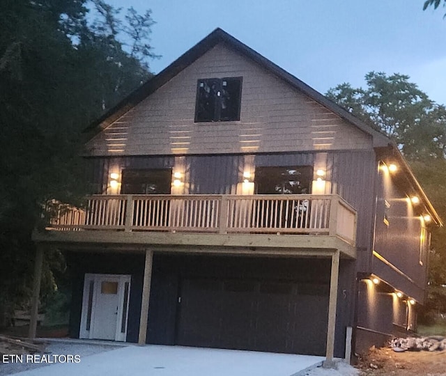 707 Powell Valley Shores Cir, Speedwell, TN 37870 - rear view of house featuring a balcony, an attached garage, and concrete driveway