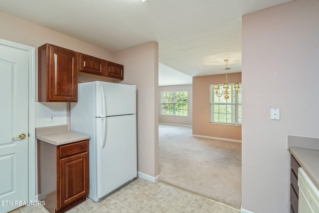 3241 Mountain Spring Way, Knoxville, TN 37917 - kitchen featuring white appliances, a chandelier, light countertops, baseboards, and light carpet