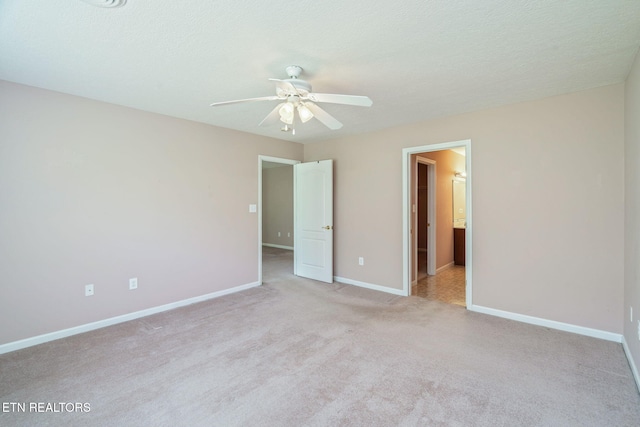 3241 Mountain Spring Way, Knoxville, TN 37917 - unfurnished bedroom featuring light carpet, baseboards, connected bathroom, and a ceiling fan