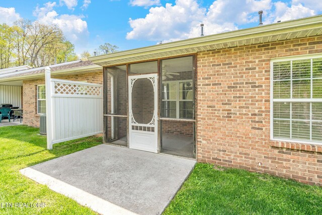 3241 Mountain Spring Way, Knoxville, TN 37917 - entrance to property featuring brick siding, a yard, and a patio