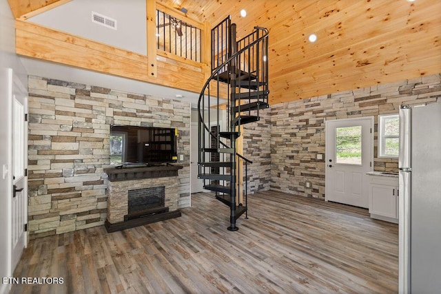 830 Hembree Hollow Rd, Townsend, TN 37882 - unfurnished living room with a towering ceiling, stairs, wood finished floors, a fireplace, and wooden ceiling