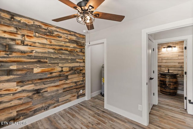 830 Hembree Hollow Rd, Townsend, TN 37882 - spare room featuring ceiling fan, electric water heater, wood finished floors, and baseboards