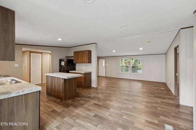 4001 Lilac Ave, Knoxville, TN 37914 - kitchen with freestanding refrigerator, light wood finished floors, a sink, a kitchen island, and light countertops