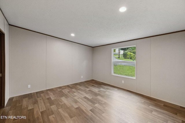 4001 Lilac Ave, Knoxville, TN 37914 - unfurnished room with wood finished floors, a textured ceiling, crown molding, and recessed lighting