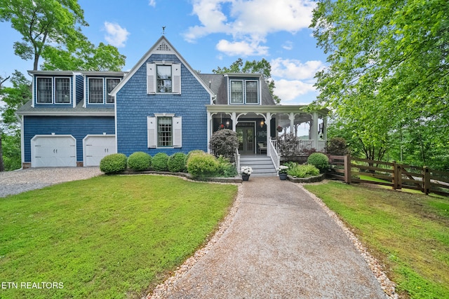 157 Wildcat Hollow Rd, New Tazewell, TN 37825 - view of front of home with a porch, gravel driveway, and an attached garage