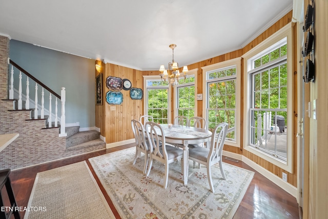 157 Wildcat Hollow Rd, New Tazewell, TN 37825 - dining area with baseboards, healthy amount of natural light, a chandelier, stairway, and wooden walls