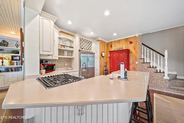 157 Wildcat Hollow Rd, New Tazewell, TN 37825 - kitchen with stainless steel fridge with ice dispenser, light countertops, cooktop, a peninsula, and wood walls