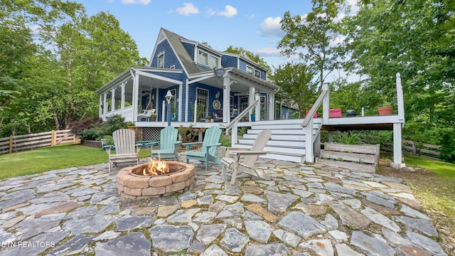 157 Wildcat Hollow Rd, New Tazewell, TN 37825 - rear view of house with an outdoor fire pit, a patio, stairway, and a sunroom