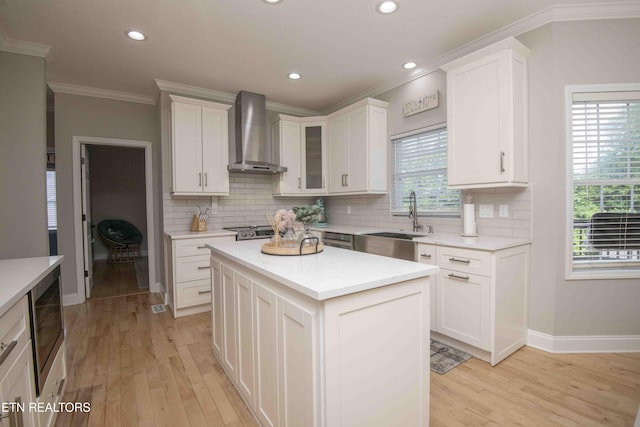160 Brentwood Pl, Lenoir City, TN 37772 - kitchen with wall chimney range hood, ornamental molding, a sink, tasteful backsplash, and light wood-style flooring