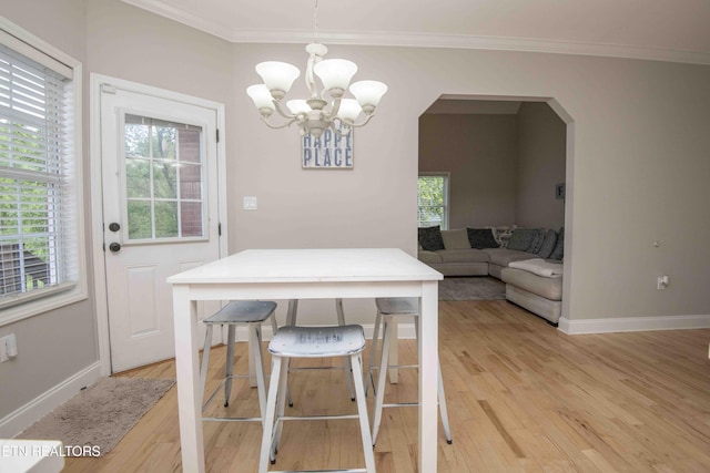 160 Brentwood Pl, Lenoir City, TN 37772 - dining space with light wood-style flooring, crown molding, a chandelier, and plenty of natural light