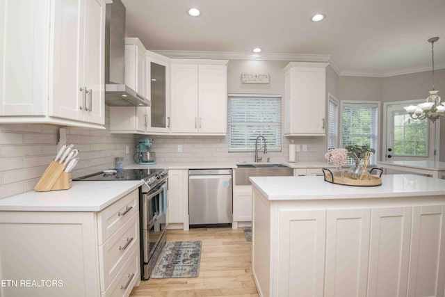 160 Brentwood Pl, Lenoir City, TN 37772 - kitchen featuring appliances with stainless steel finishes, wall chimney exhaust hood, a sink, white cabinetry, and crown molding