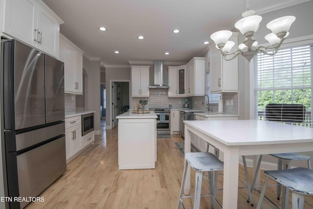 160 Brentwood Pl, Lenoir City, TN 37772 - kitchen with appliances with stainless steel finishes, wall chimney range hood, crown molding, a center island, and decorative backsplash