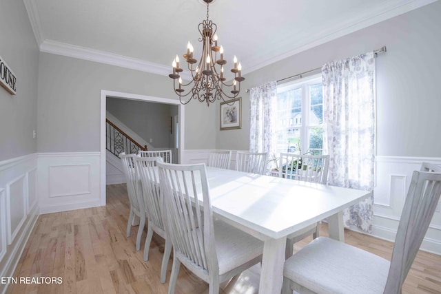 160 Brentwood Pl, Lenoir City, TN 37772 - dining space featuring a chandelier, a wainscoted wall, a decorative wall, crown molding, and light wood-style flooring