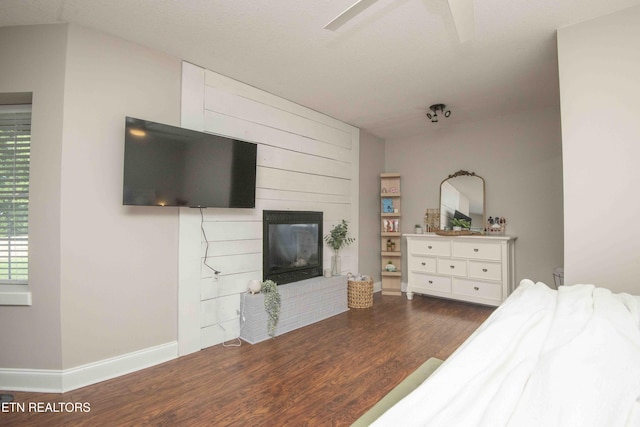 160 Brentwood Pl, Lenoir City, TN 37772 - bedroom with wood finished floors, a large fireplace, baseboards, and a ceiling fan