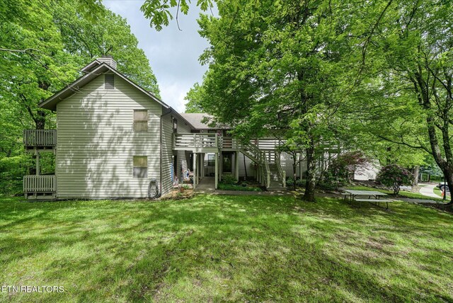 281 Moytoy Rd Unit 204, Crab Orchard, TN 37723 - back of property featuring a chimney, stairs, a lawn, and a wooden deck