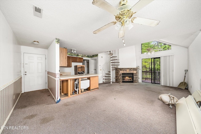 281 Moytoy Rd Unit 204, Crab Orchard, TN 37723 - unfurnished living room featuring light carpet, a textured ceiling, a ceiling fan, wainscoting, and lofted ceiling