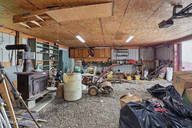 180 Stevenson Branch Rd, Middlesboro, KY 40965 - garage featuring a wood stove and a garage door opener