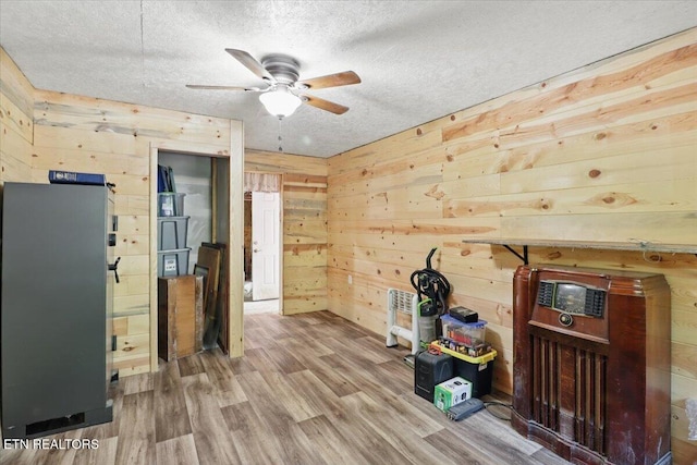 180 Stevenson Branch Rd, Middlesboro, KY 40965 - interior space with wood walls, a ceiling fan, a textured ceiling, and wood finished floors