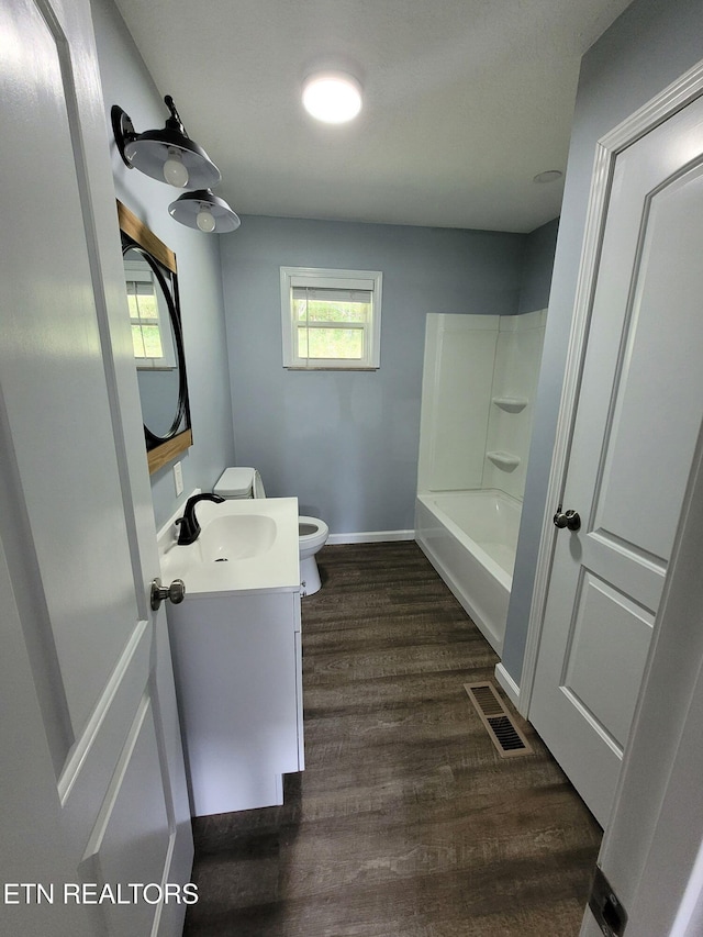 3694 Hickory Valley Rd, Maynardville, TN 37807 - full bathroom with toilet, vanity, wood finished floors, tub / shower combination, and baseboards