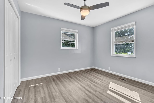 3694 Hickory Valley Rd, Maynardville, TN 37807 - unfurnished bedroom with a closet, multiple windows, wood finished floors, and baseboards