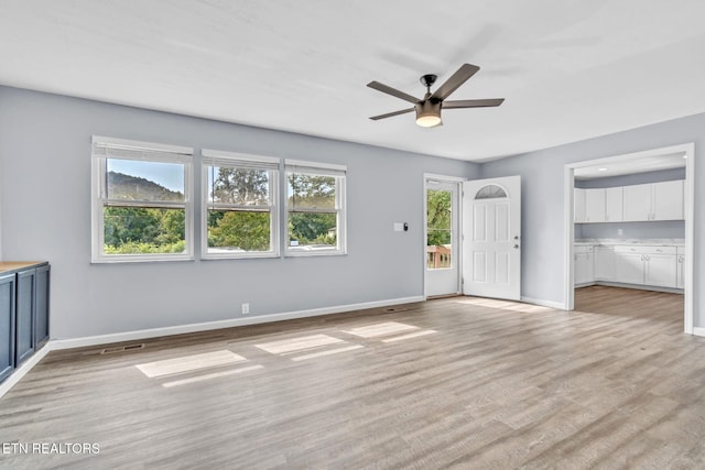 3694 Hickory Valley Rd, Maynardville, TN 37807 - unfurnished living room with a ceiling fan, light wood-type flooring, and baseboards
