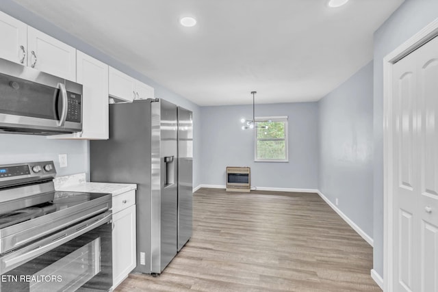 3694 Hickory Valley Rd, Maynardville, TN 37807 - kitchen with appliances with stainless steel finishes, heating unit, white cabinets, light wood finished floors, and hanging light fixtures