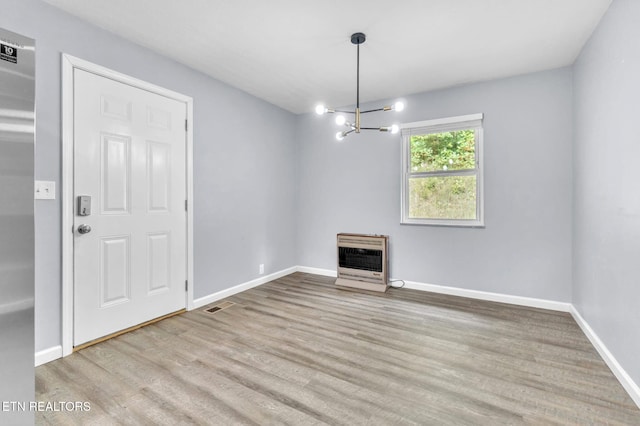 3694 Hickory Valley Rd, Maynardville, TN 37807 - unfurnished dining area with heating unit, a chandelier, wood finished floors, and baseboards