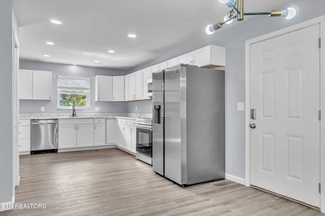 3694 Hickory Valley Rd, Maynardville, TN 37807 - kitchen featuring appliances with stainless steel finishes, white cabinets, light wood finished floors, a sink, and recessed lighting