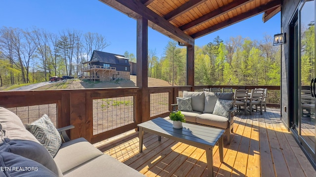wooden deck with an outdoor living space
