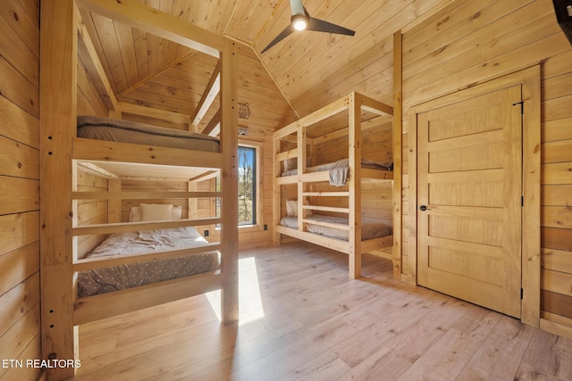 unfurnished bedroom with wood walls, wooden ceiling, hardwood / wood-style flooring, and lofted ceiling