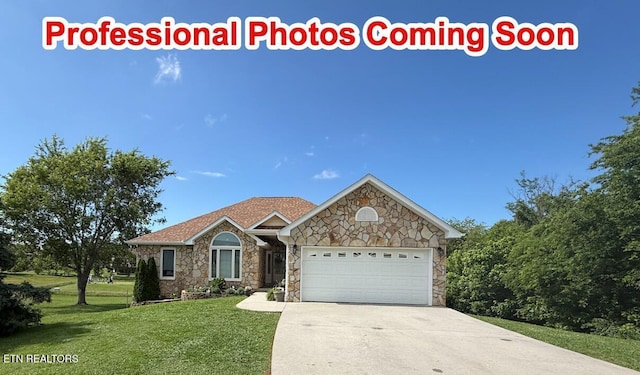 407 Kahite Trl, Vonore, TN 37885 - view of front of house with stone siding, a front yard, an attached garage, and concrete driveway