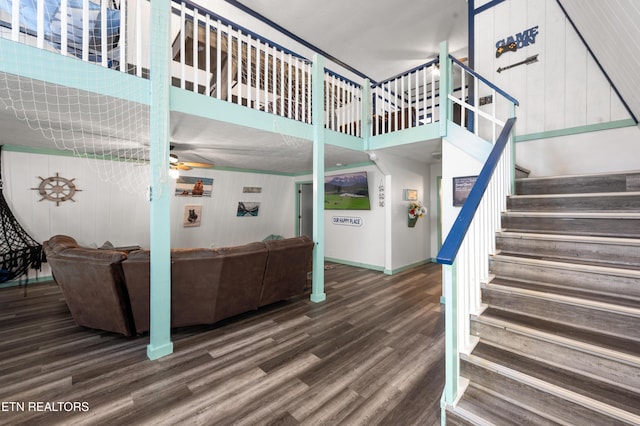 1917 Bootbluff Trl, Dandridge, TN 37725 - stairway with wood finished floors, wooden walls, a ceiling fan, baseboards, and a towering ceiling