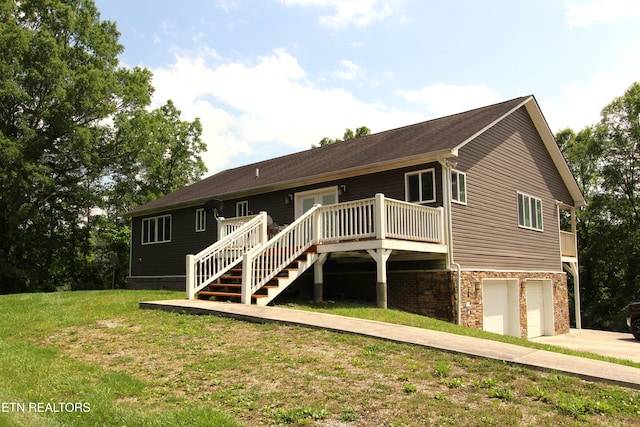 241 Oswego Rd, Jellico, TN 37762 - back of property featuring a deck, an attached garage, stairs, a yard, and driveway