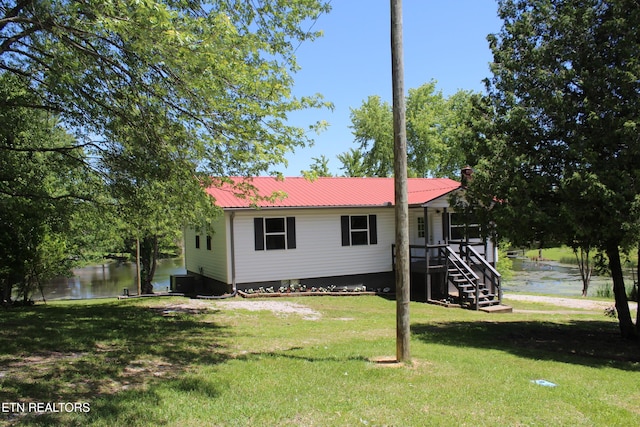 515 Silver Lake Dr, Jamestown, TN 38556 - rear view of house with a yard, a water view, and metal roof