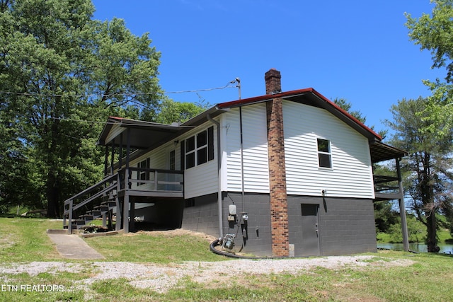 515 Silver Lake Dr, Jamestown, TN 38556 - view of home's exterior featuring a chimney, a yard, stairs, and a wooden deck