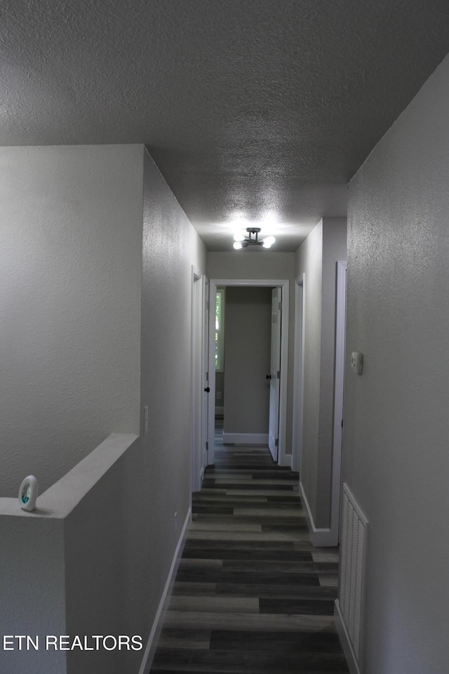515 Silver Lake Dr, Jamestown, TN 38556 - corridor featuring a textured ceiling, wood finished floors, and baseboards