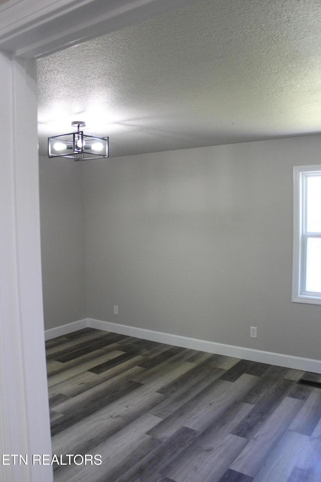 515 Silver Lake Dr, Jamestown, TN 38556 - empty room featuring dark wood-type flooring, a textured ceiling, and baseboards