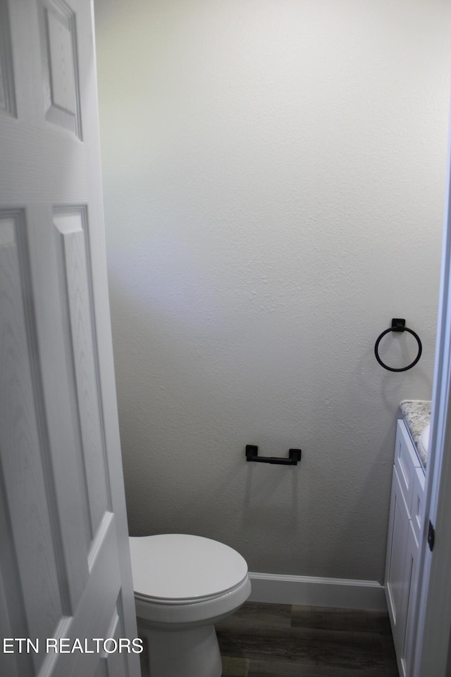 515 Silver Lake Dr, Jamestown, TN 38556 - bathroom with baseboards, toilet, wood finished floors, and vanity
