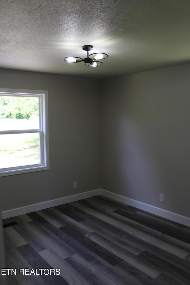 515 Silver Lake Dr, Jamestown, TN 38556 - empty room featuring dark wood finished floors, a textured ceiling, and baseboards