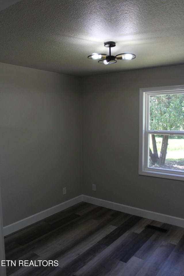 515 Silver Lake Dr, Jamestown, TN 38556 - spare room featuring dark wood finished floors, a textured ceiling, and baseboards