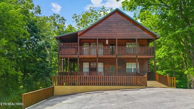 view of front of home featuring uncovered parking and log siding