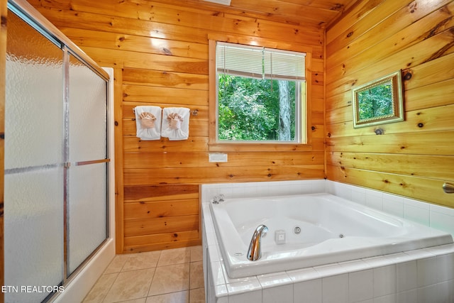 full bathroom with wooden walls, a shower stall, tile patterned floors, and a tub with jets