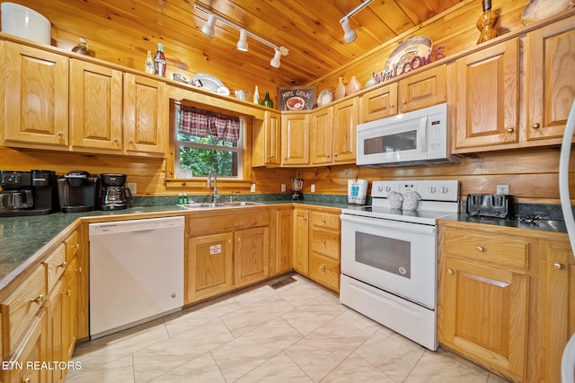 kitchen featuring white appliances, a sink, and track lighting